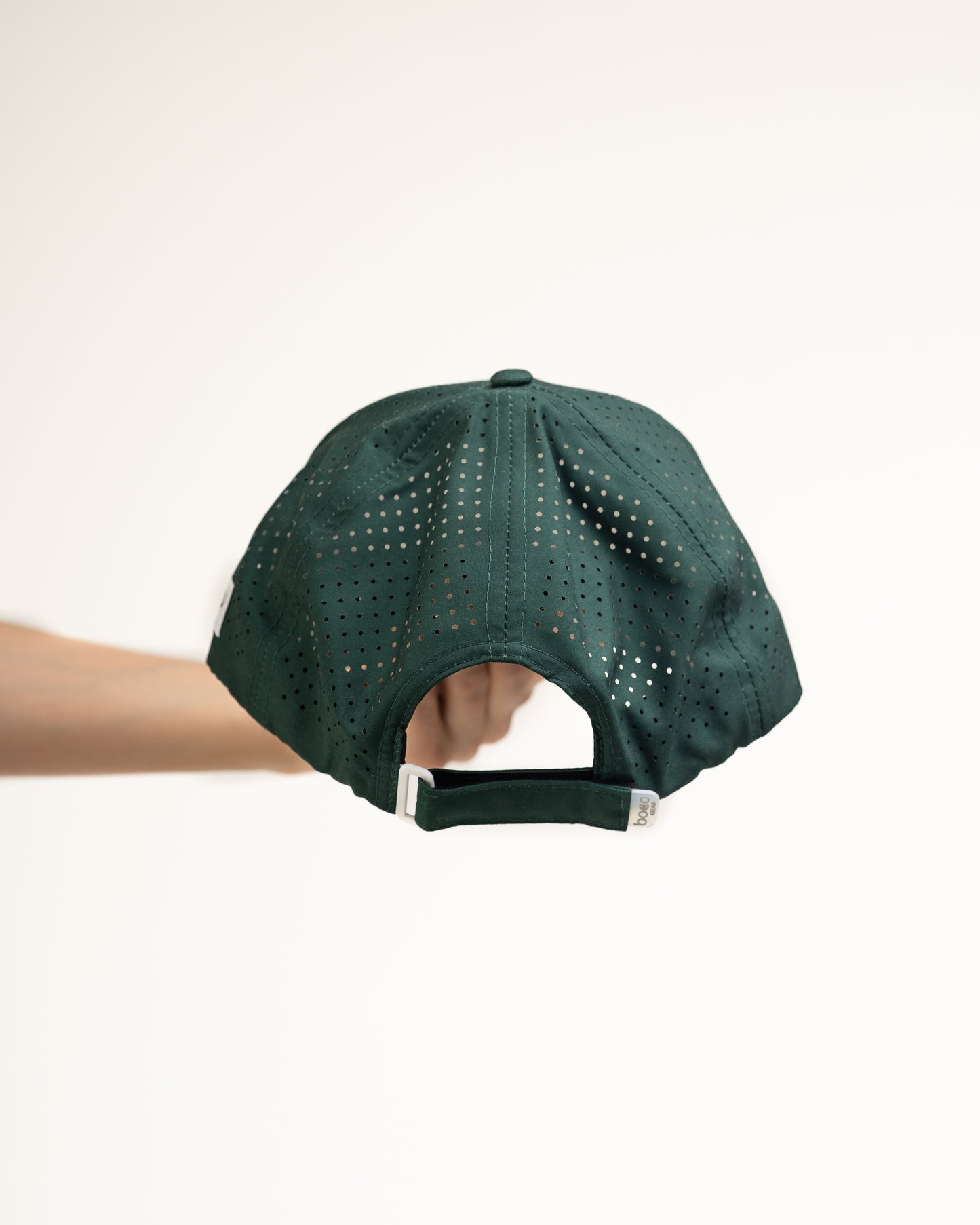 Rear view of the Pursuit Hat highlighting the laser-cut ventilation panels for breathability and the adjustable soft-touch closure.