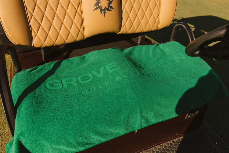 Grove + Green golf green 100% terry cloth golf cart seat cover towel on a golf cart.
