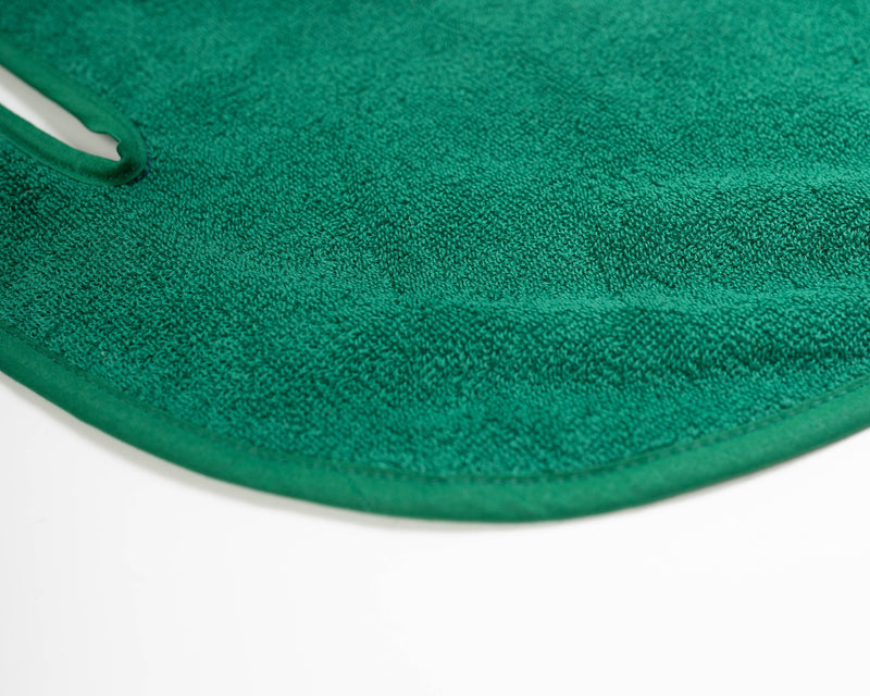 Close up detail of Grove + Green's signature 100% terry cloth golf cart seat towel with green trim.