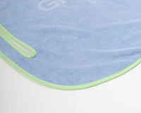 Close up detail of Grove + Green's signature 100% terry cloth golf cart seat towel with green trim.