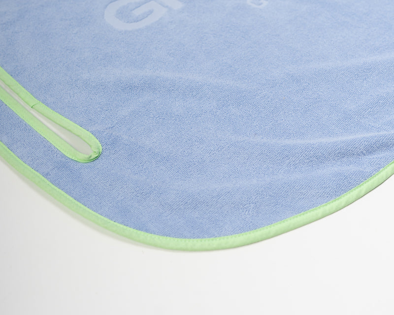 Close up detail of Grove + Green's signature 100% terry cloth golf cart seat towel with green trim.