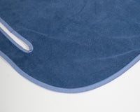 Close up detail of Grove + Green's signature 100% terry cloth golf cart seat towel with classic blue trim.