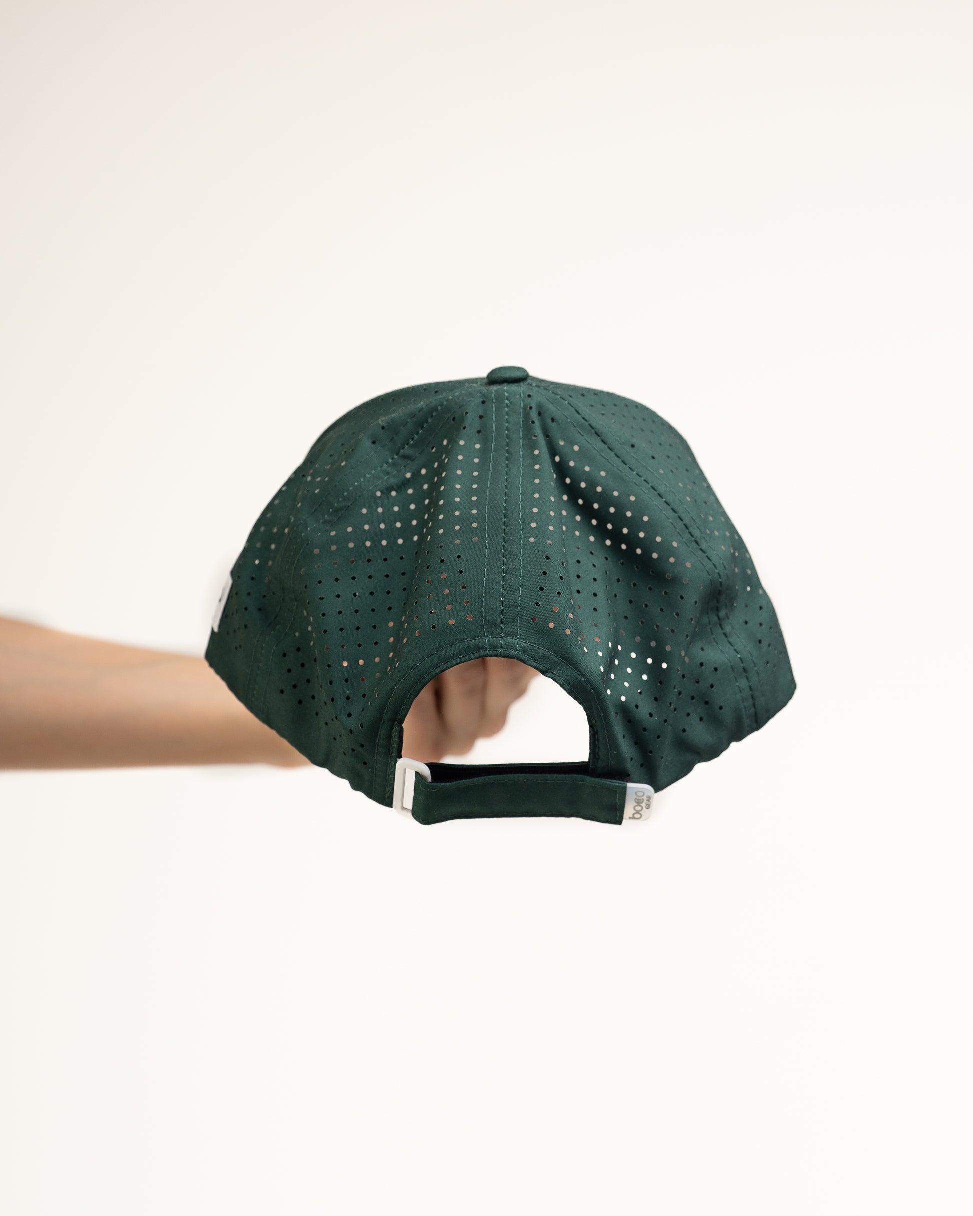 Rear view of the Pursuit Hat highlighting the laser-cut ventilation panels for breathability and the adjustable soft-touch closure.
