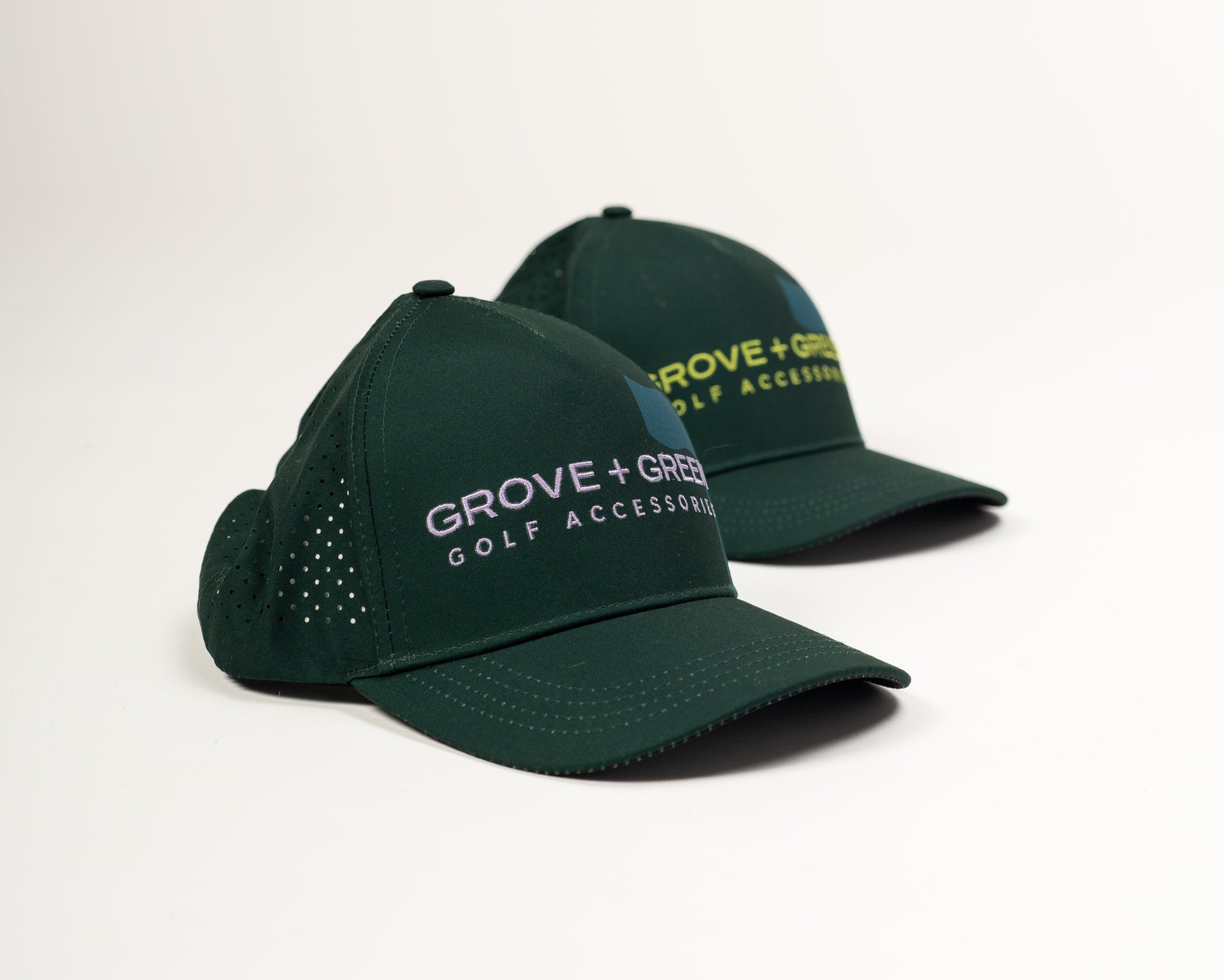 Side by side profile of the Grove + Green Pursuit Hat in forest green and lilac showing the structured 5-panel design.