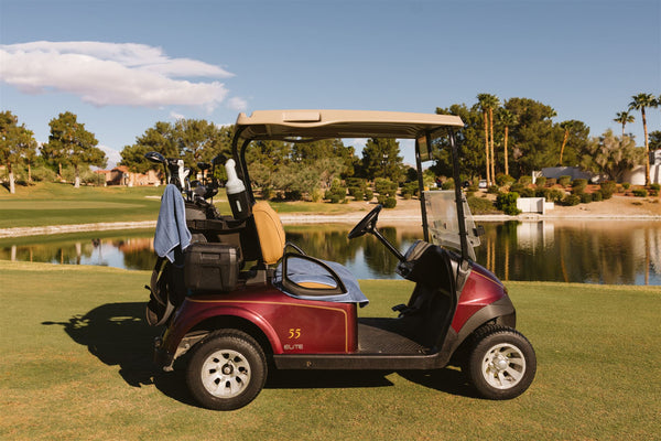 Burgundy golf cart with Grove + Green signature 100% terry cloth golf cart seat cover in navy blue.