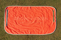Grove + Green orange coral 100% terry cloth golf cart seat towel with light blue trim.