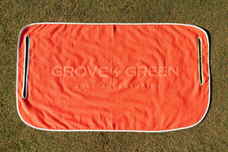 Grove + Green orange coral 100% terry cloth golf cart seat towel with light blue trim.