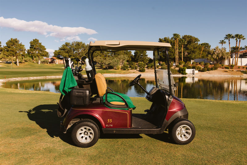 Burgundy golf cart with Grove + Green signature 100% terry cloth golf cart seat cover in golf green.